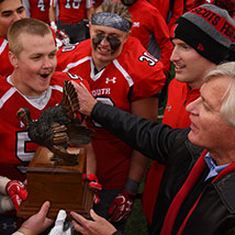 Football team holding a trophy. Links to Tangible Personal Property